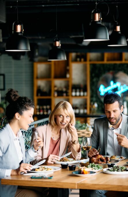 Group of entrepreneurs having business lunch in restaurant.