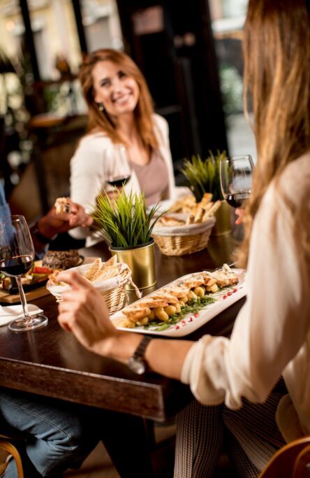 Two young women at a dinner in a restaurant